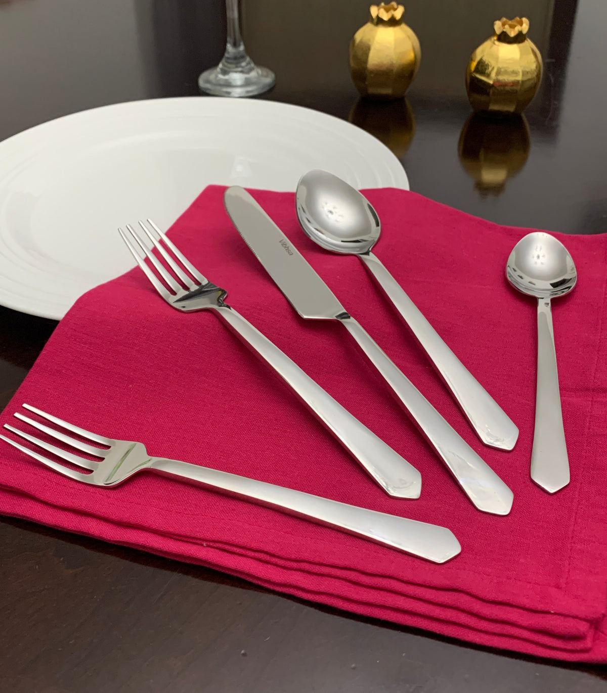 Vibhsa 20-piece flatware set in stainless steel with forks, knives, and spoons on a red napkin on Tampa Home & Garden Store
