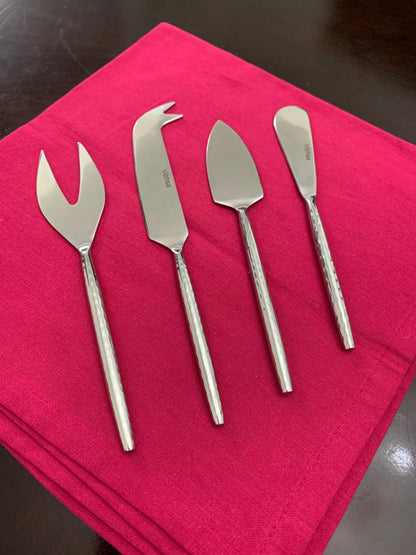 Vibhsa stainless steel cheese knives set of 4 with varied blade styles on pink cloth on Tampa Home & Garden Store