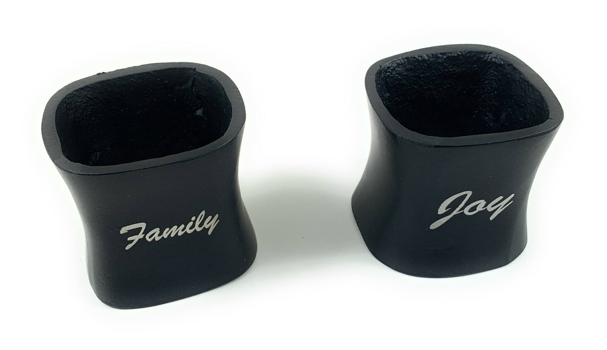 Two black Vibhsa Christmas napkin rings with white Family script on Tampa Home & Garden Store