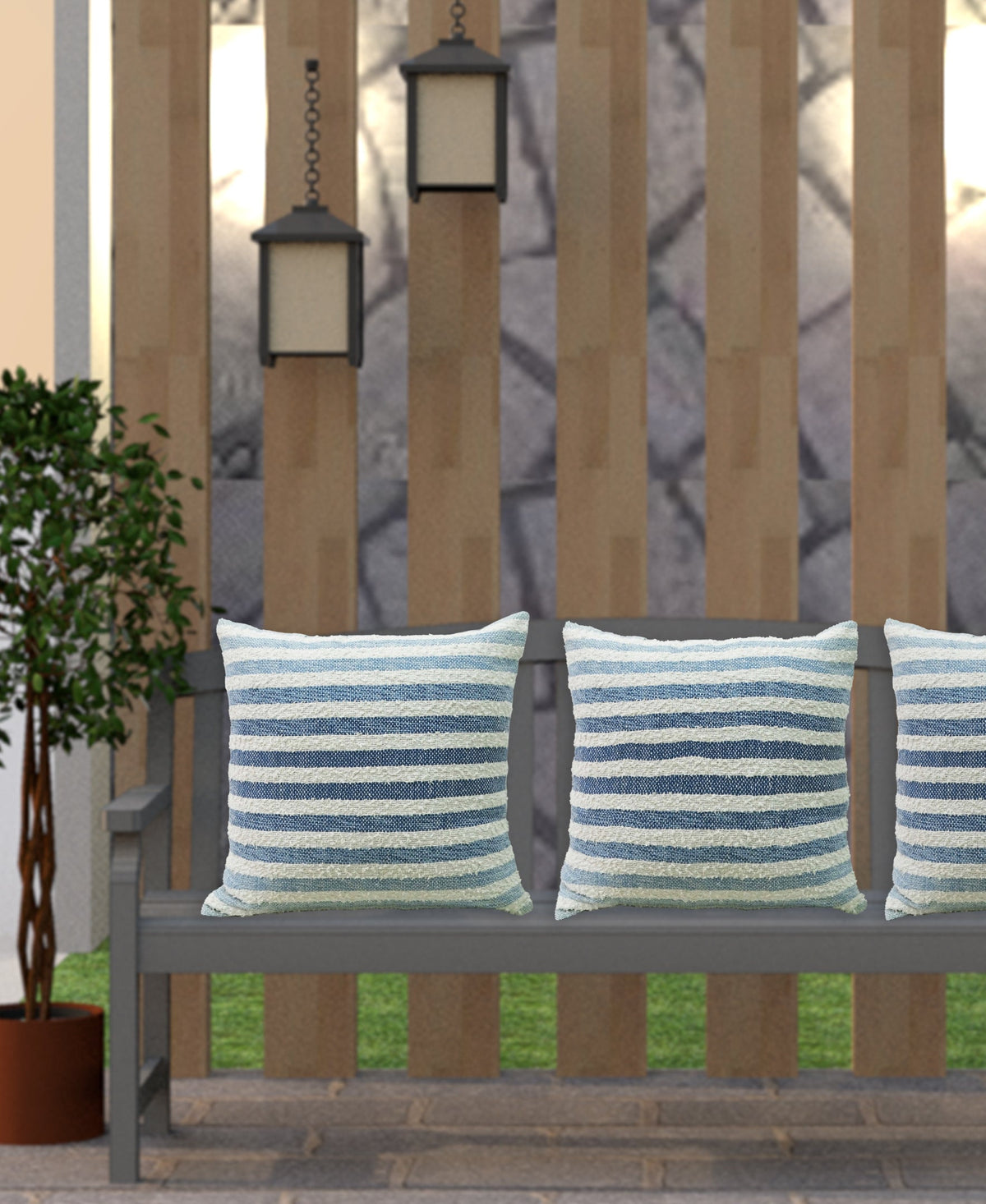 Vibhsa 100% cotton ombre stripe throw pillow, blue/white striped, 2 shown on outdoor bench on Tampa Home & Garden Store
