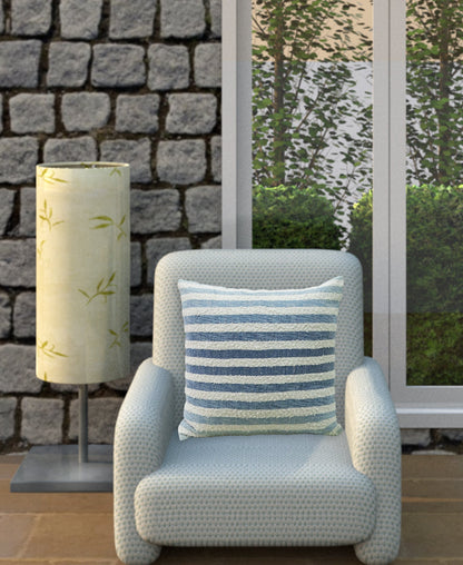 Vibhsa throw pillow 100% cotton ombre textured stripe in blue and white on a light woven chair on Tampa Home & Garden Store