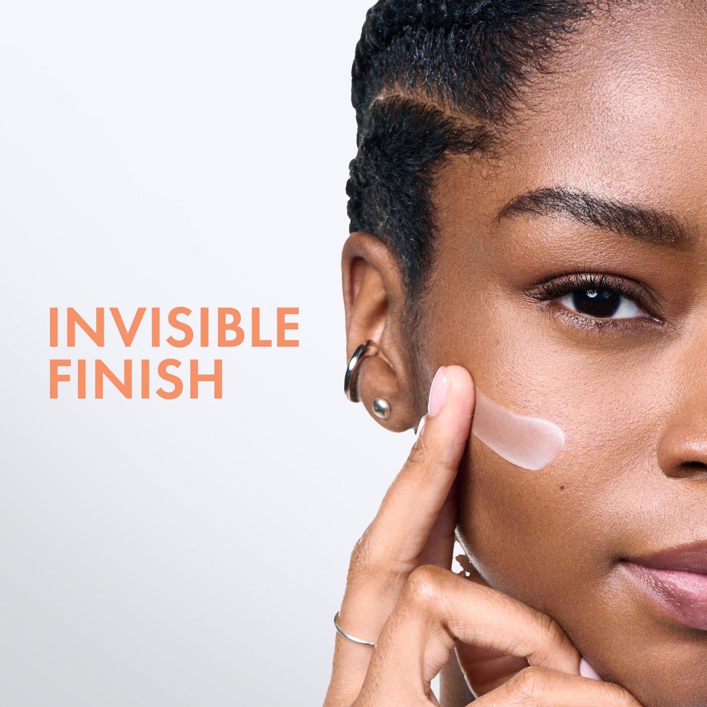 Sunscreen emulsion close-up on model’s face with peach INVISIBLE FINISH text on Tampa Home & Garden Store