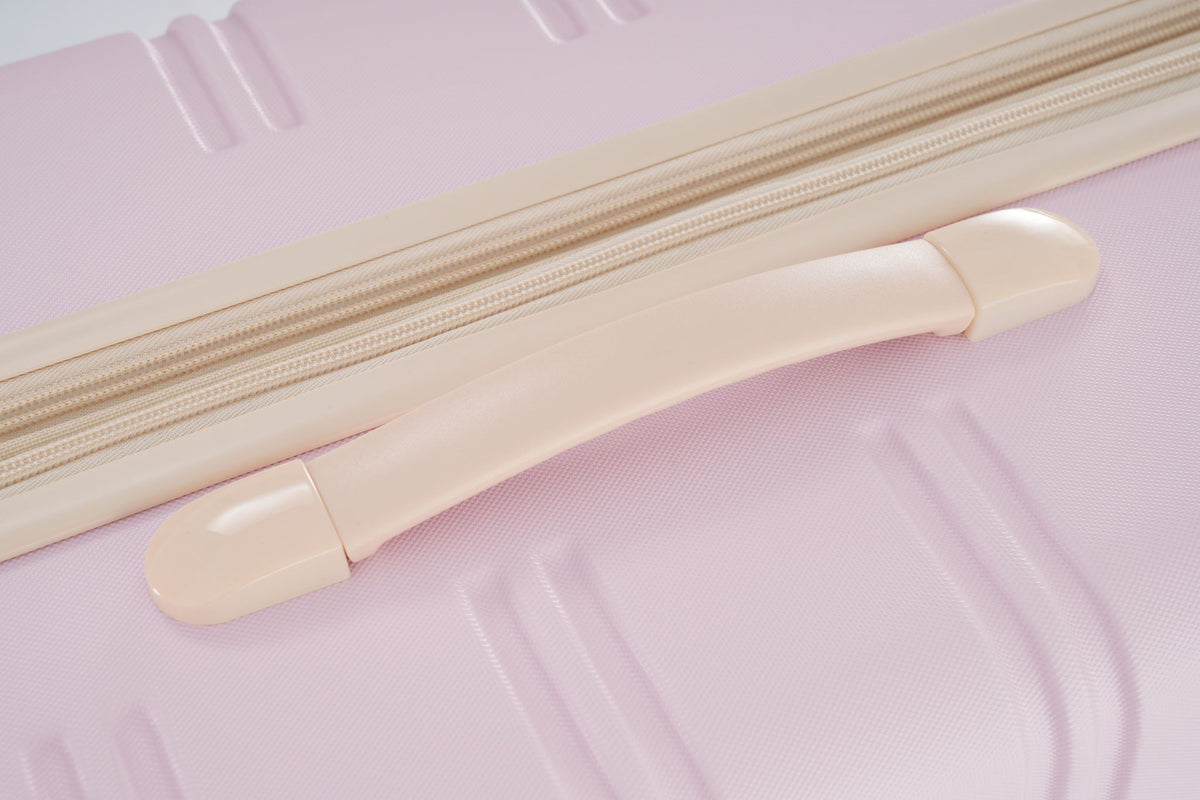 Luggage zipper close-up on beige hardside suitcase fabric on Tampa Home & Garden Store