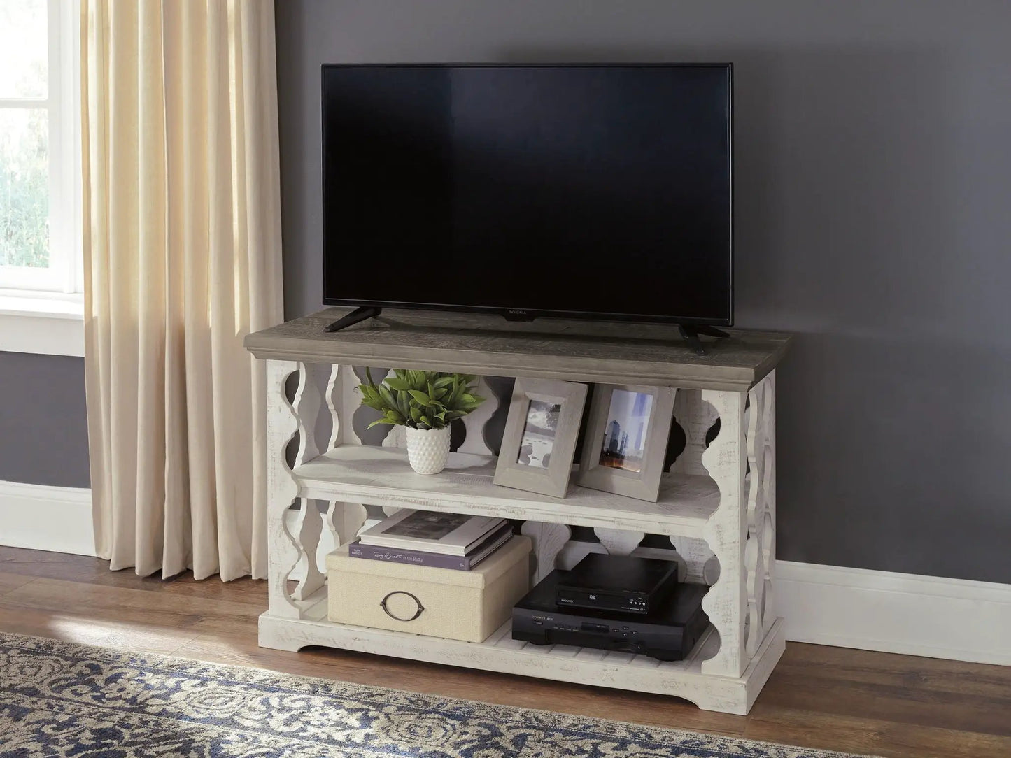 Havalance console sofa table gray/white by Unique Piece Furniture with TV on top and frames on shelf on Tampa Home & Garden Store