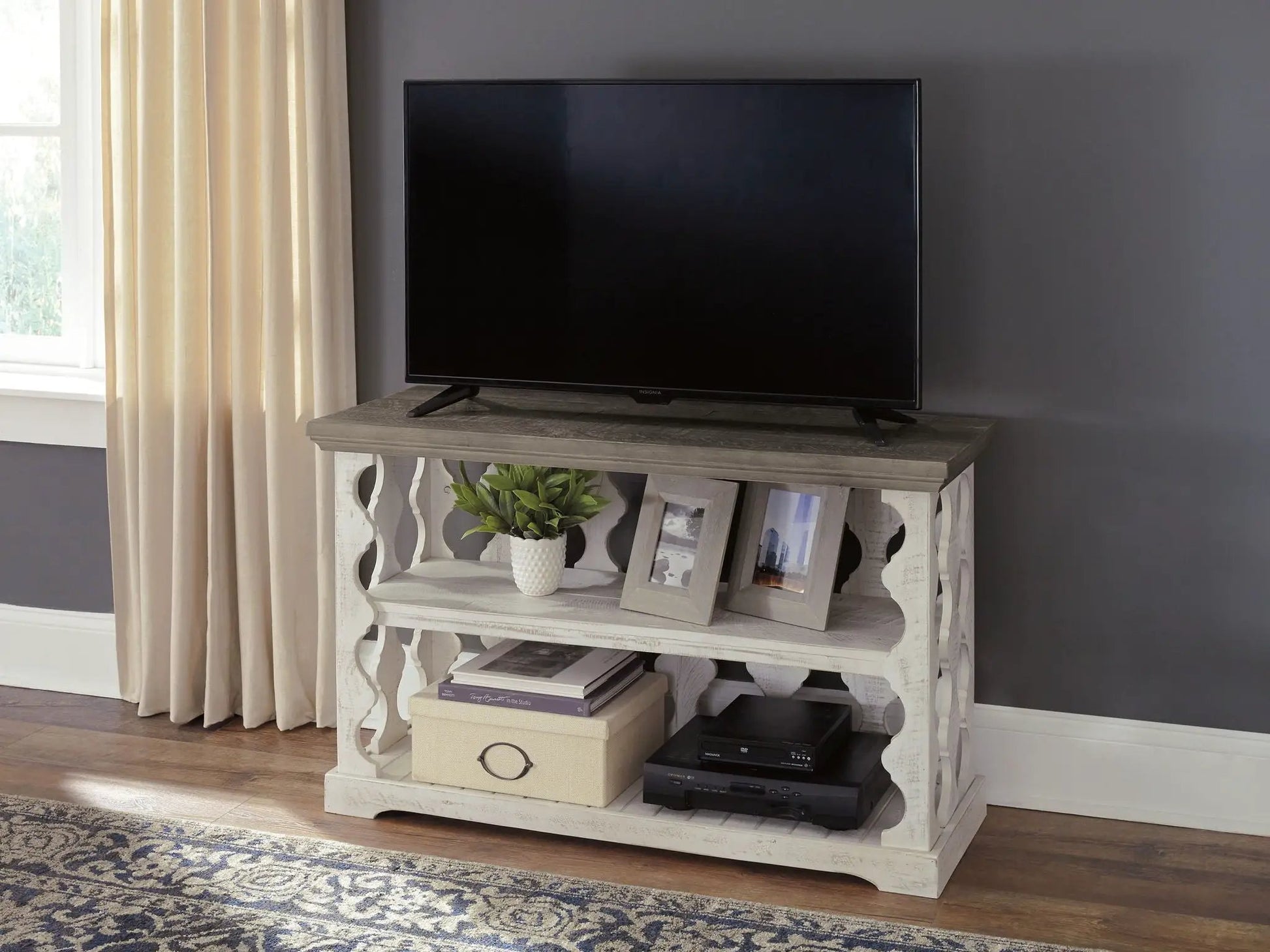 Havalance console sofa table gray/white by Unique Piece Furniture with TV on top and frames on shelf on Tampa Home & Garden Store