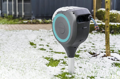 Garden Hose Box RollUp S 15m hose reel by Gardena mounted on a stake in snowy yard on Tampa Home & Garden Store