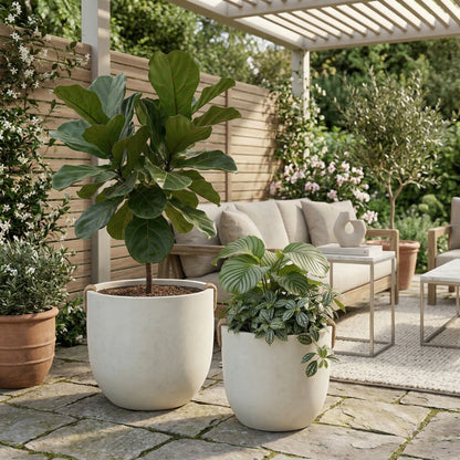 Round concrete planters set of 2, large off-white pots with leafy green plants on a patio on Tampa Home & Garden Store