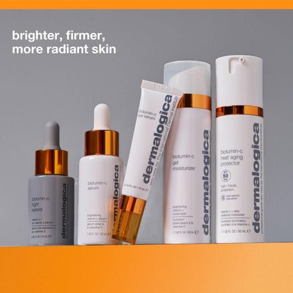Dermalogica Biolumin-C Eye Serum tube with white bottles and orange caps on gray background on Tampa Home & Garden Store