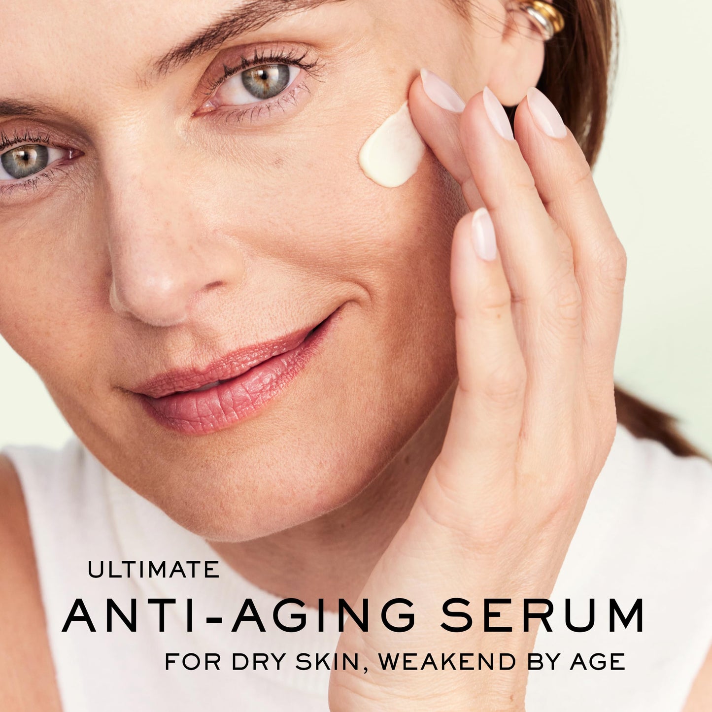 Face serum Nuxe Nuxuriance Gold Anti-Aging Serum hyaluronic acid, applied to cheek on Tampa Home & Garden Store