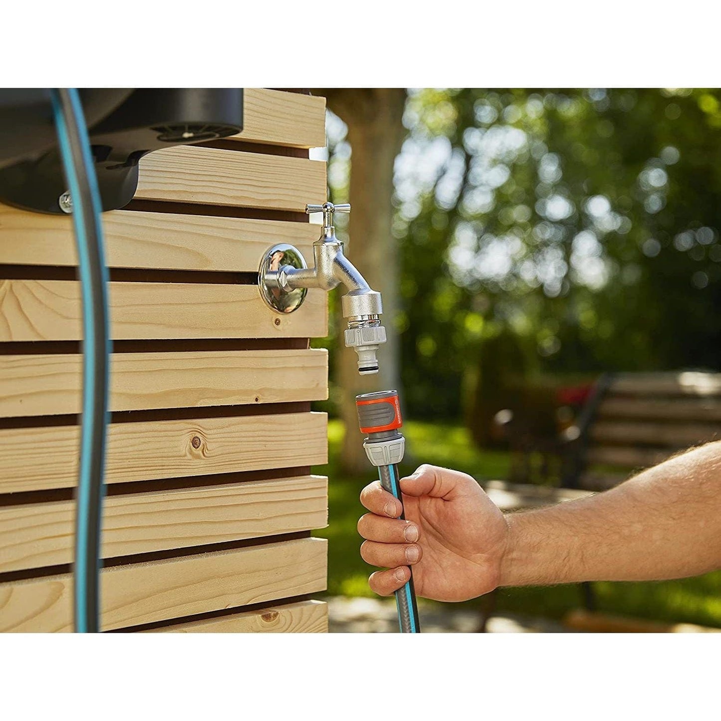 Wall-Mounted Hose Box RollUp XL 35m Gardena with chrome faucet and blue hose on wooden wall on Tampa Home & Garden Store