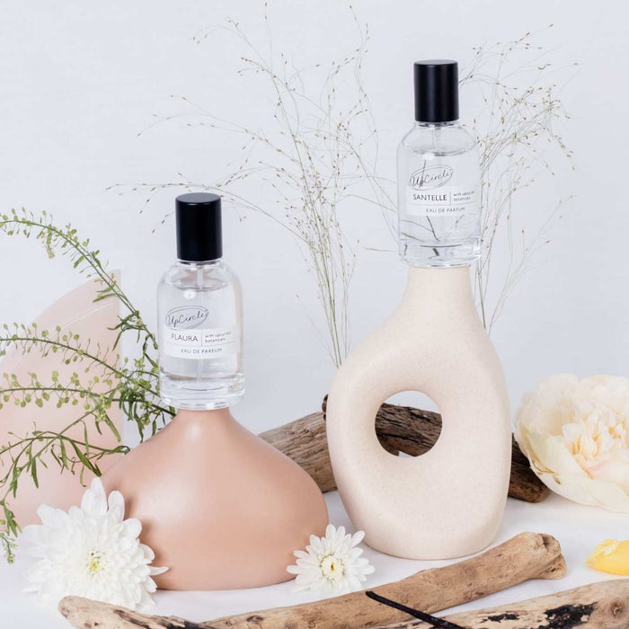 UpCircle Eau De Parfum Set Flaura + Santelle, two clear bottles with black caps on beige vases on Tampa Home & Garden Store