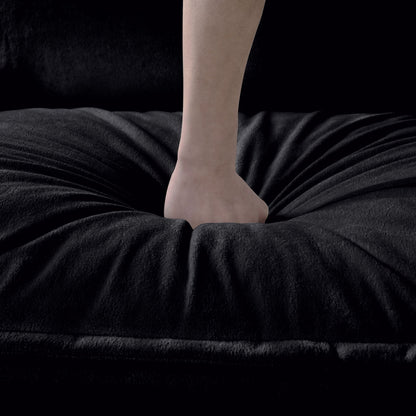 Bare leg on plush black velvet fabric surface on Tampa Home & Garden Store