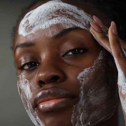 Exfoliator foamy cleanser on dark skin; close-up of fingers with pink nails on Tampa Home & Garden Store
