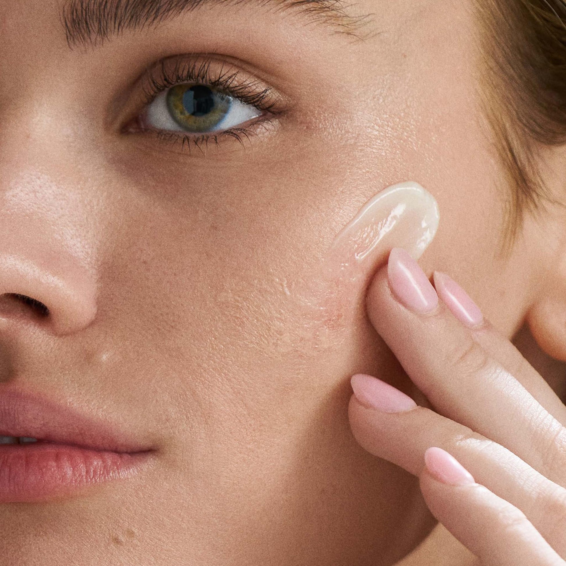 Dermalogica PowerBright Overnight Cream being applied to cheek; close-up skincare by Beauty Care Bag on Tampa Home & Garden Store