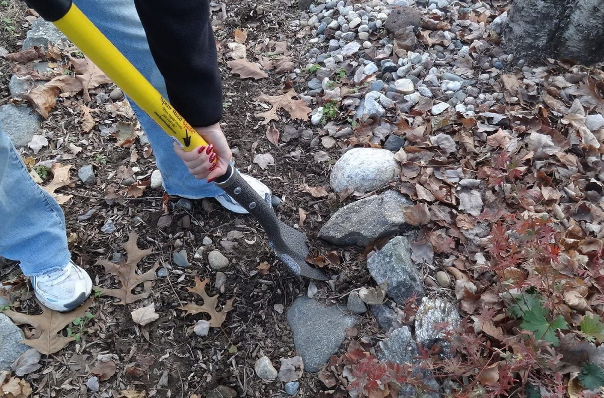 Spear Head Spade 40in D-grip digging spade with yellow handle in rocky garden bed on Tampa Home & Garden Store