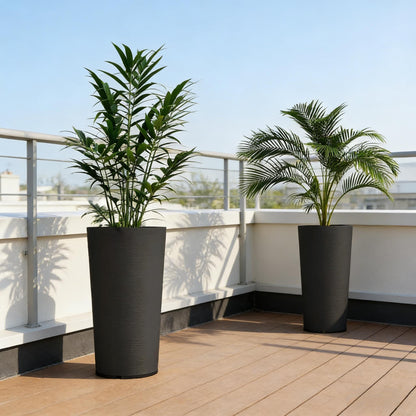 Set of 2 stackable large flower pots in black with tall leafy plants on a balcony railing on Tampa Home & Garden Store
