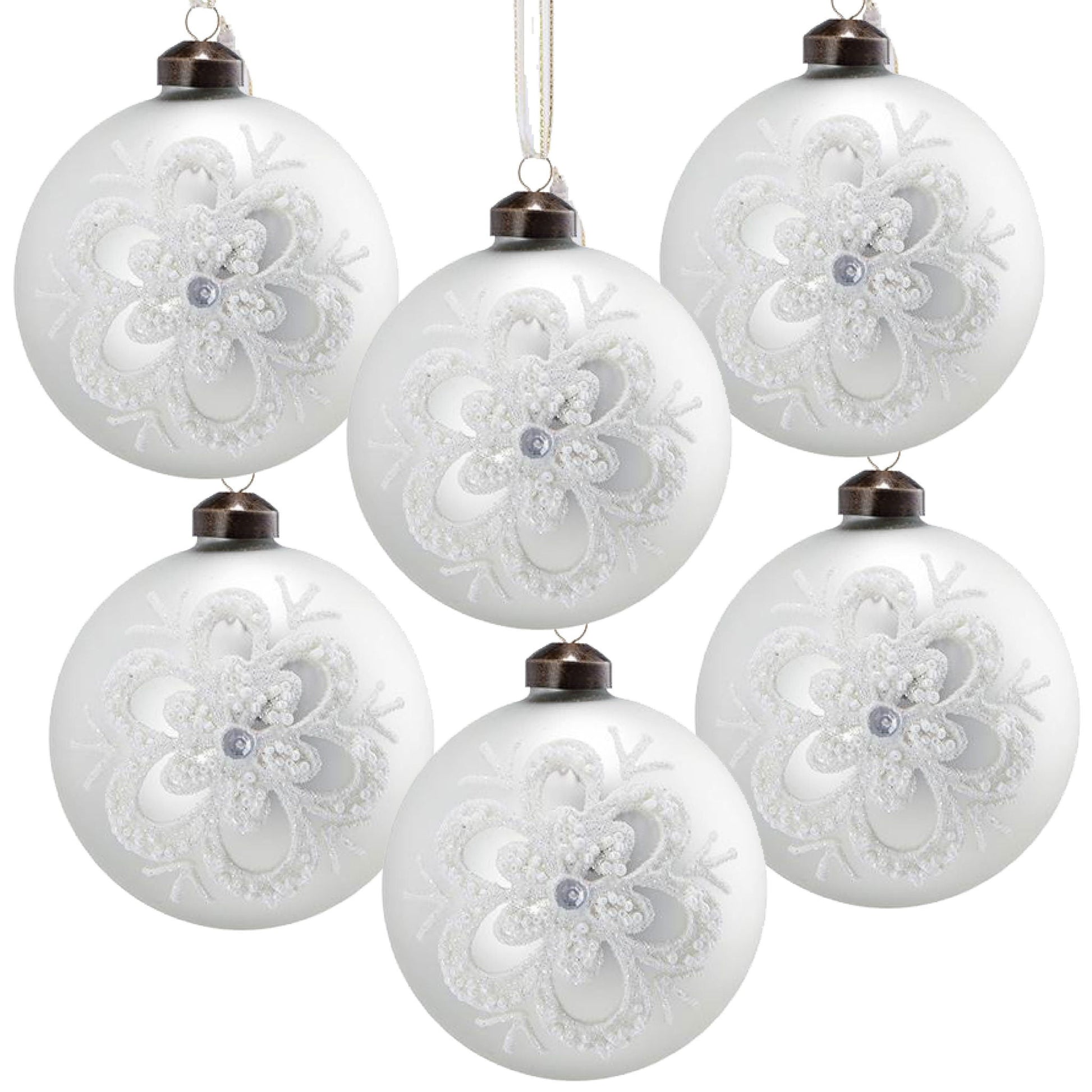 White glass Christmas ball ornaments with embossed glitter lace snowflake pattern, hanging from bronze caps on Tampa Home & Garden Store