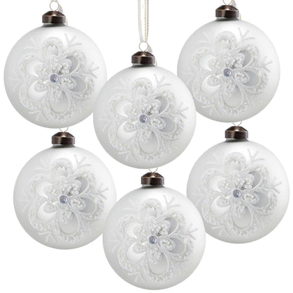 White glass Christmas ball ornaments with embossed glitter lace snowflake pattern, hanging from bronze caps on Tampa Home & Garden Store