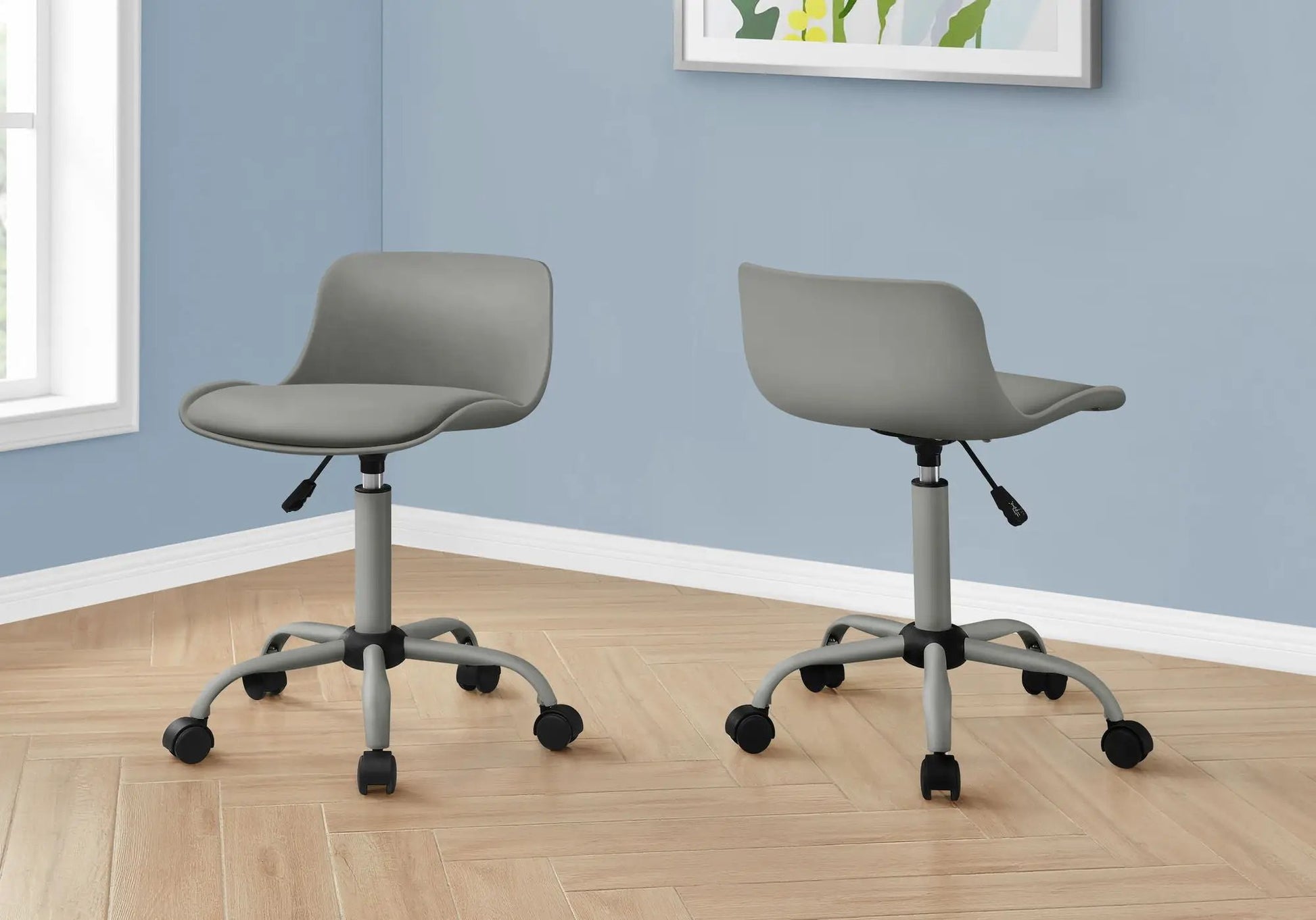 Two ergonomic office chairs with adjustable height and swivel bases on a blue wall backdrop on Tampa Home & Garden Store