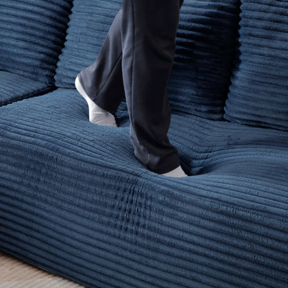 105'' Modular Sectional Sofa in deep blue fabric with chaise; person stepping on the sofa on Tampa Home & Garden Store