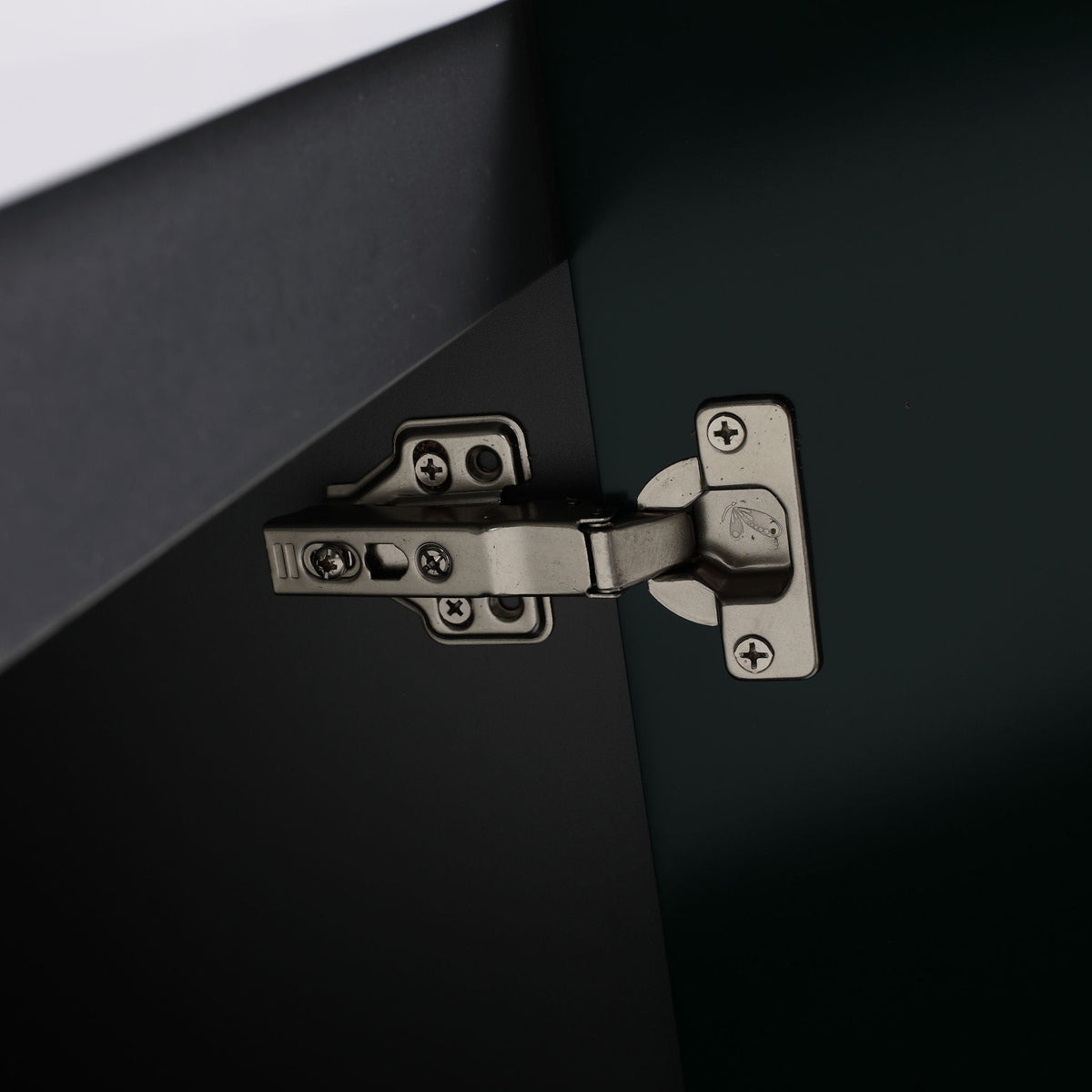 Freestanding bathroom vanity soft-close hinge close-up on dark cabinet panel on Tampa Home & Garden Store
