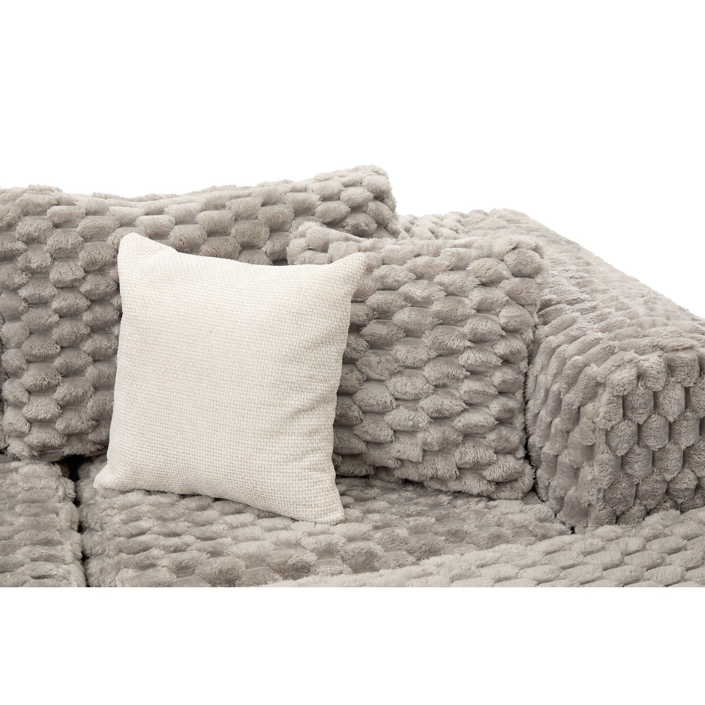 Modular sectional sofa closeup with plush taupe blanket texture and beige woven pillow on Tampa Home & Garden Store
