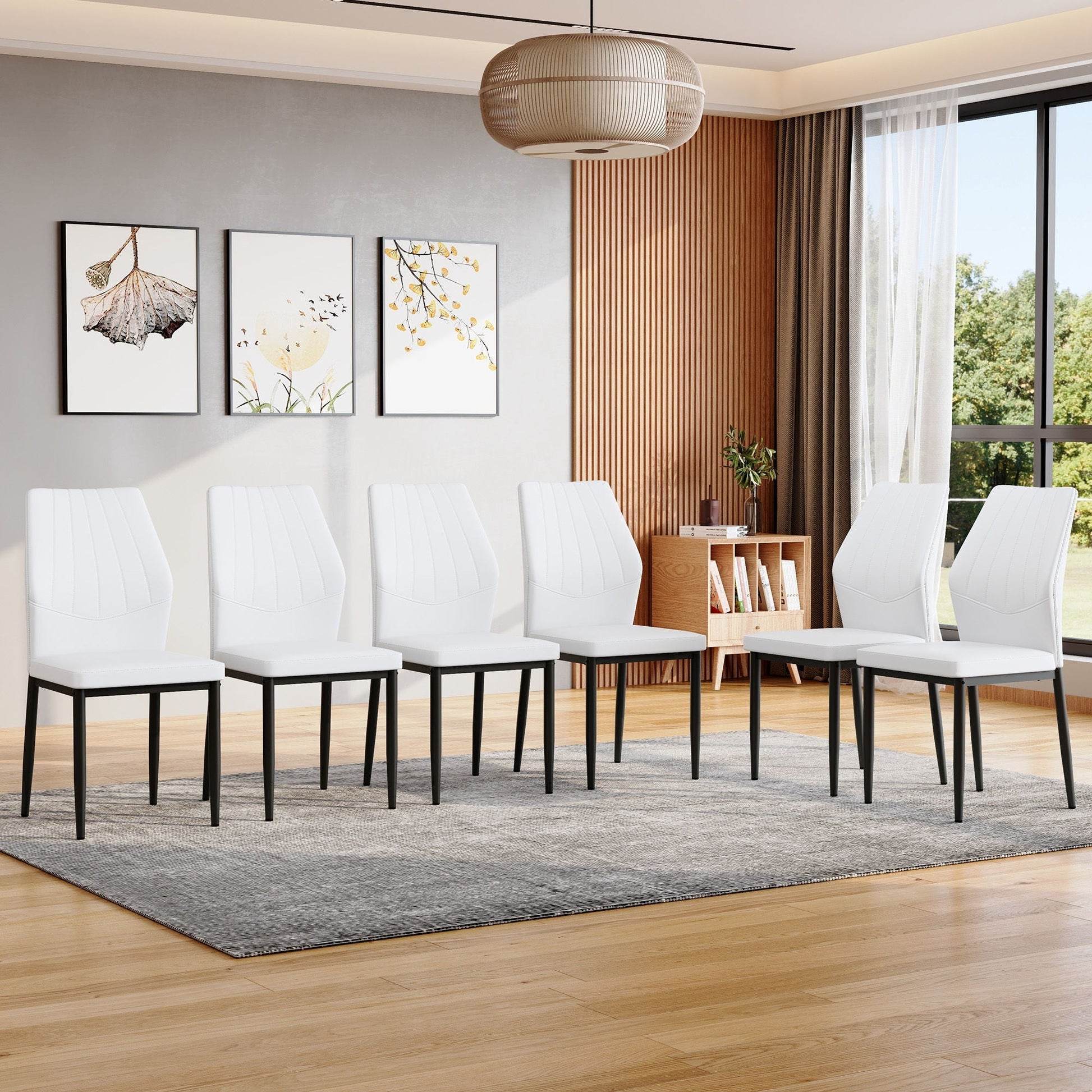 Dining chairs with shell pattern, white upholstery and black legs in a modern dining room on Tampa Home & Garden Store