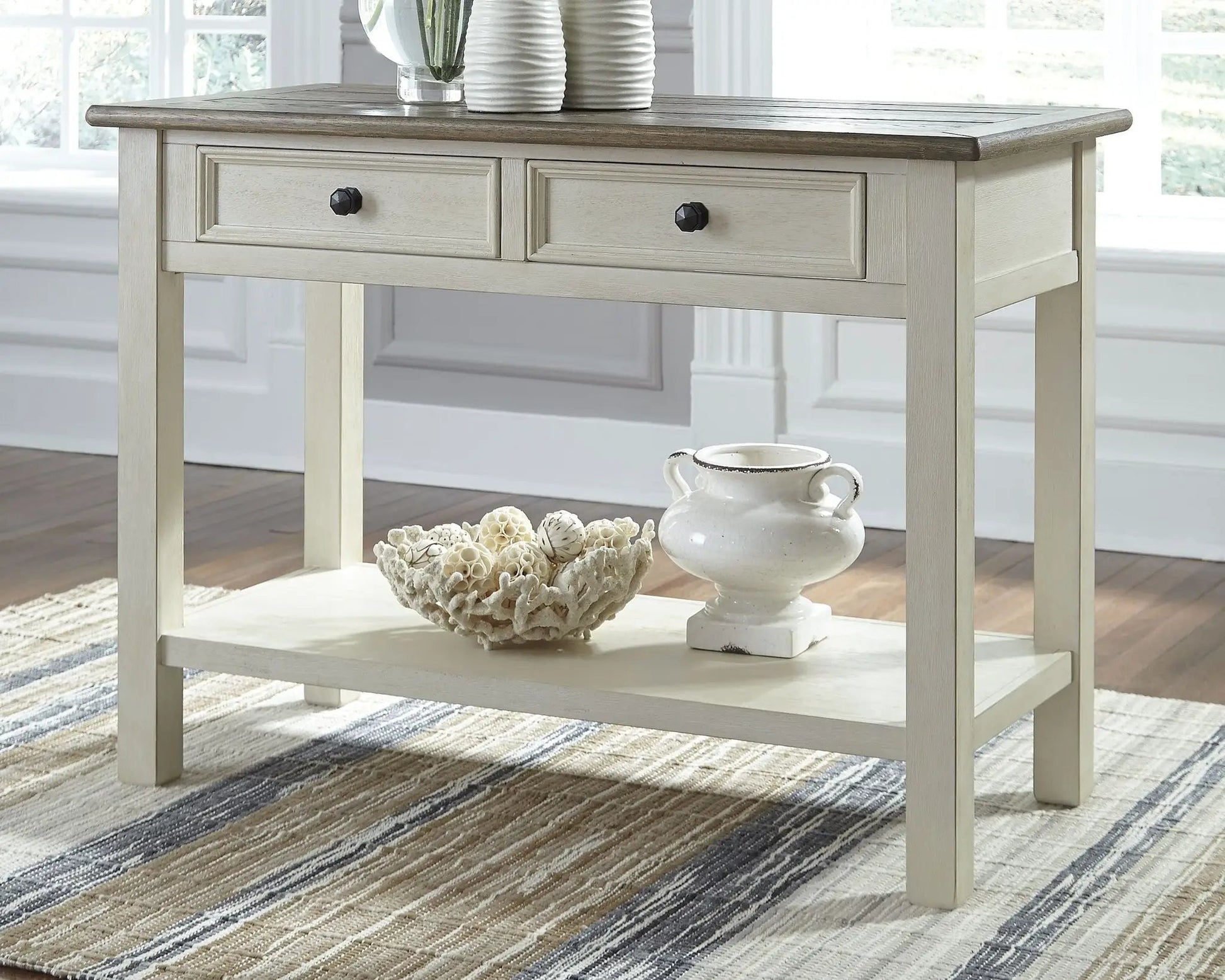 Bolanburg sofa table with pale gray wash finish, dark wood top, two drawers with black knobs on Tampa Home & Garden Store