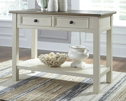 Bolanburg sofa table with pale gray wash finish, dark wood top, two drawers with black knobs on Tampa Home & Garden Store