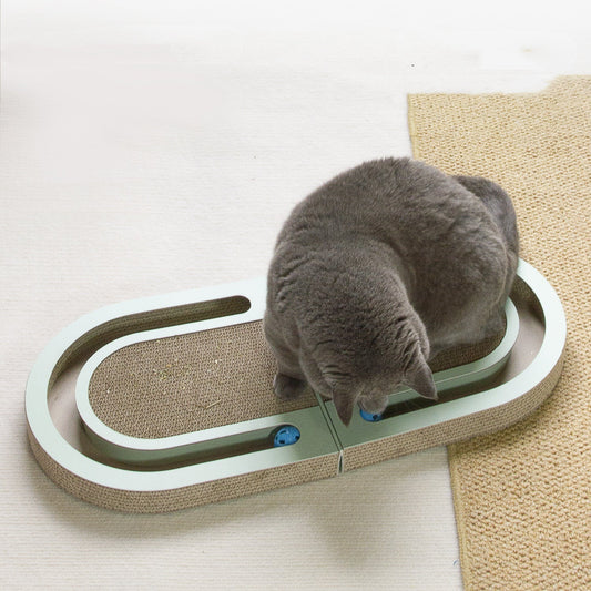 Corrugated paper folding cat grab board in green frame with ball; cat using it on Tampa Home & Garden Store
