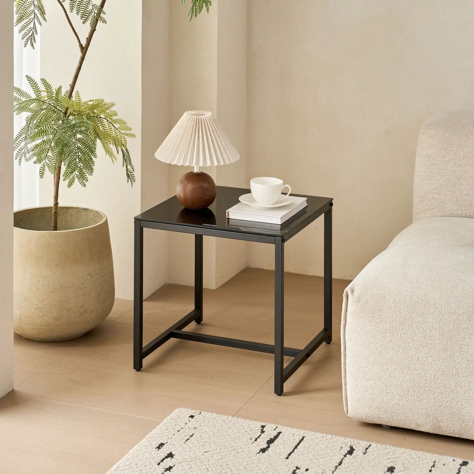 Table For Living Room coffee table with black metal frame and glass top in a living room on Tampa Home & Garden Store