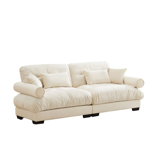 Modern stationary sofa with cream leather upholstery, bolstered armrests and multiple pillows on Tampa Home & Garden Store