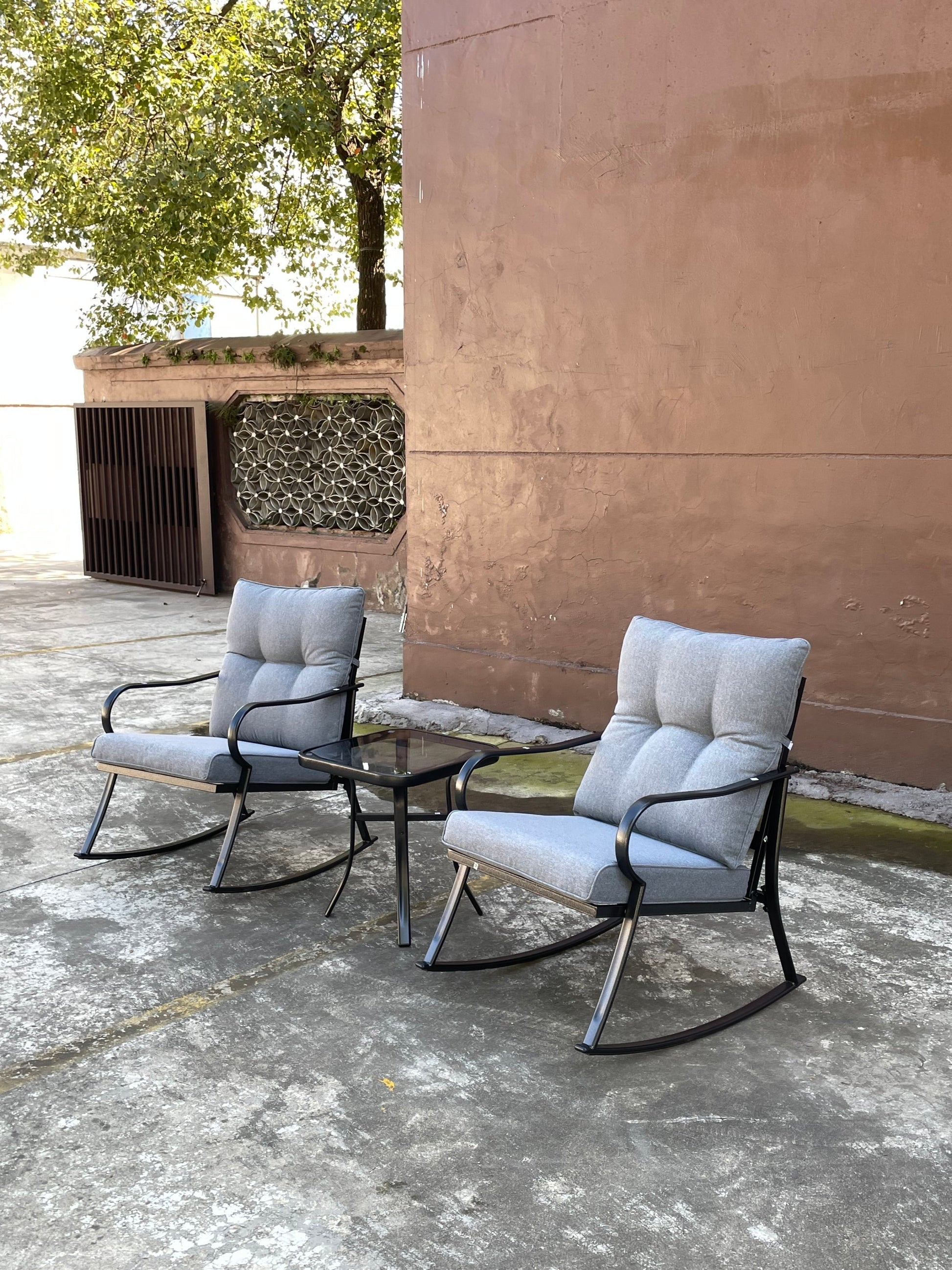 Two rocker chairs and teapoy outdoor set with grey cushions, black metal frames, glass table on Tampa Home & Garden Store