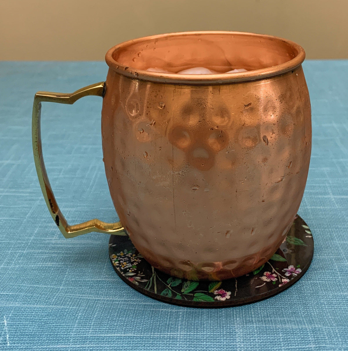 Vibhsa Hammered Moscow Mule Mugs set of 2 copper finish with brass handles and ice in mugs on Tampa Home & Garden Store