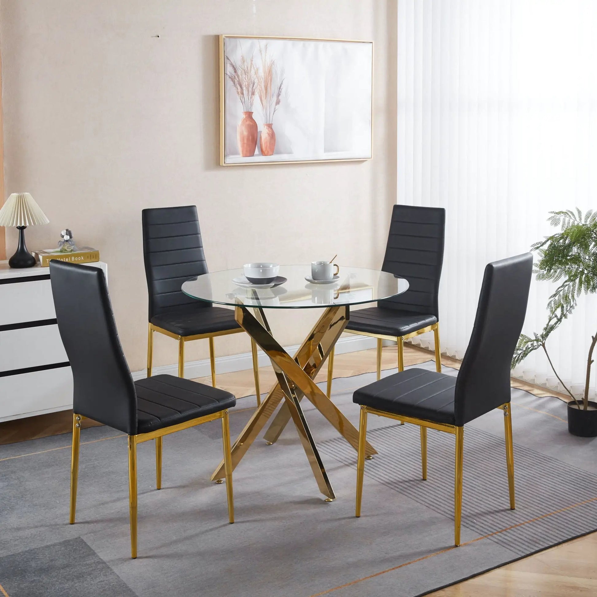 Elegant Legs Dining Chair set of 4 black faux-leather seats with gold legs around a glass dining table on Tampa Home & Garden Store