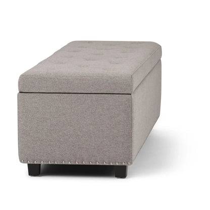 Hamilton Upholstered Storage Ottoman by Unique Piece in gray fabric with nailhead trim and legs on Tampa Home & Garden Store