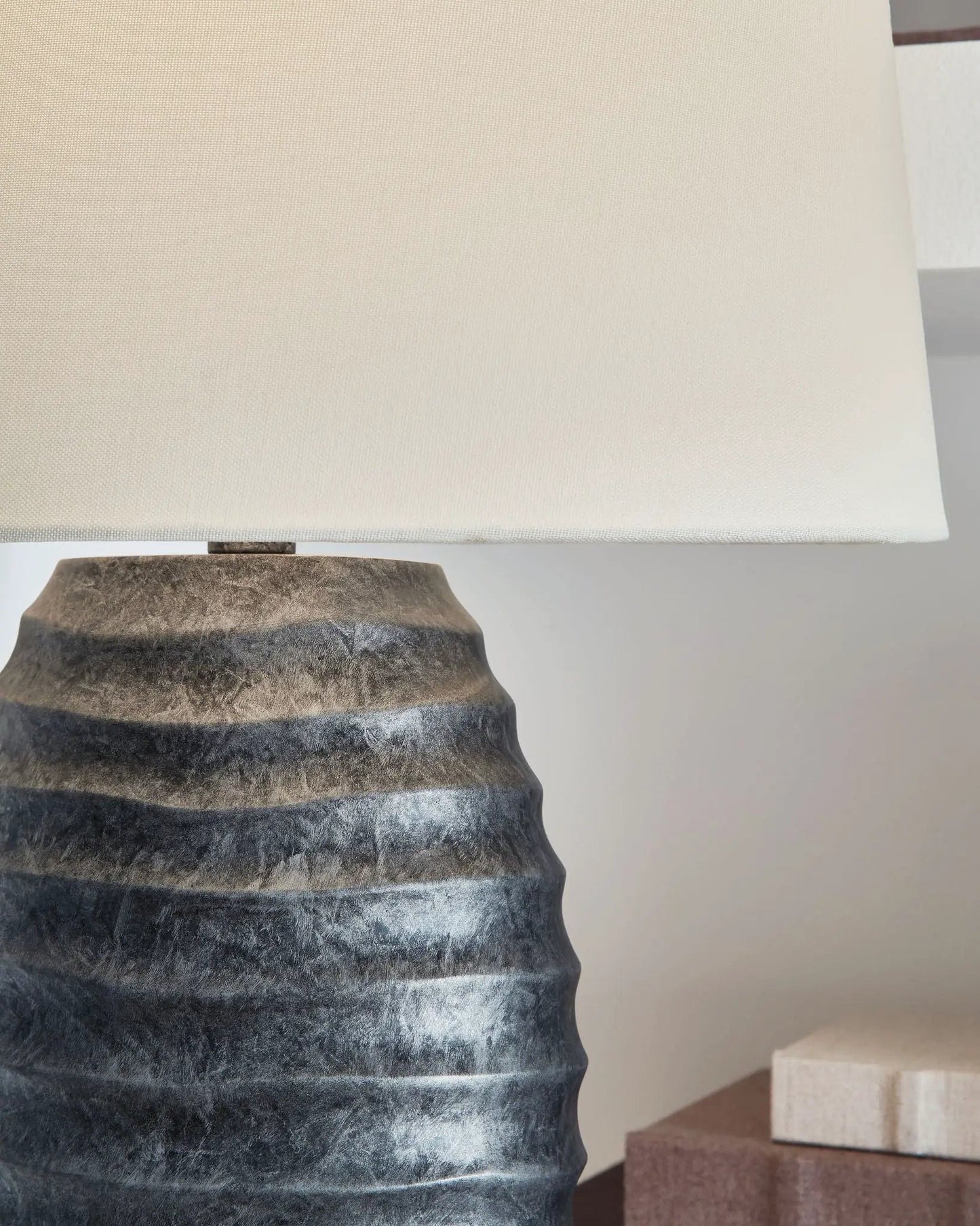 Caronick poly table lamp antique silver finish with ribbed dark base and beige fabric shade on Tampa Home & Garden Store