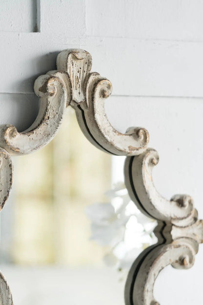 Diamond scrollwork wall mirror in antique white distressed finish with ornate carved frame on Tampa Home & Garden Store