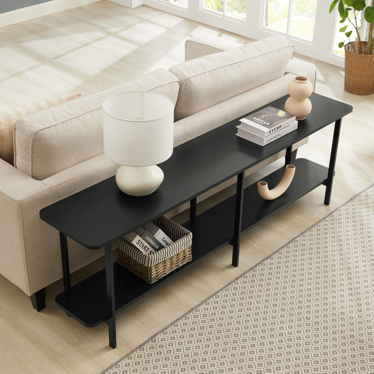 Celine 2-Shelf Console Table in black with two tiers beside a beige sofa in a bright living room on Tampa Home & Garden Store