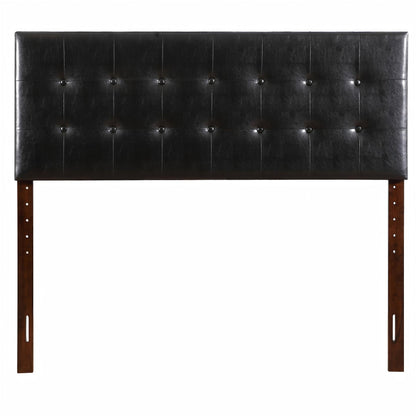Black upholstered headboard with button-tufted panels and wooden legs on Tampa Home & Garden Store