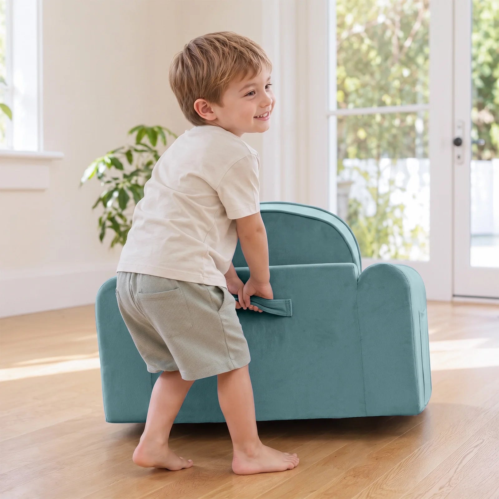 Tiny Land INC GentleSnug Kids Sofa Chair teal fabric; child leaning on it in a living room on Tampa Home & Garden Store