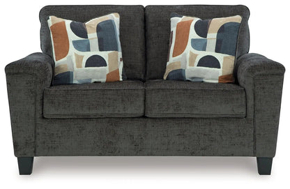 Erinslane Living Room Set stationary chair & ottoman in dark gray fabric with bold pillows on Tampa Home & Garden Store