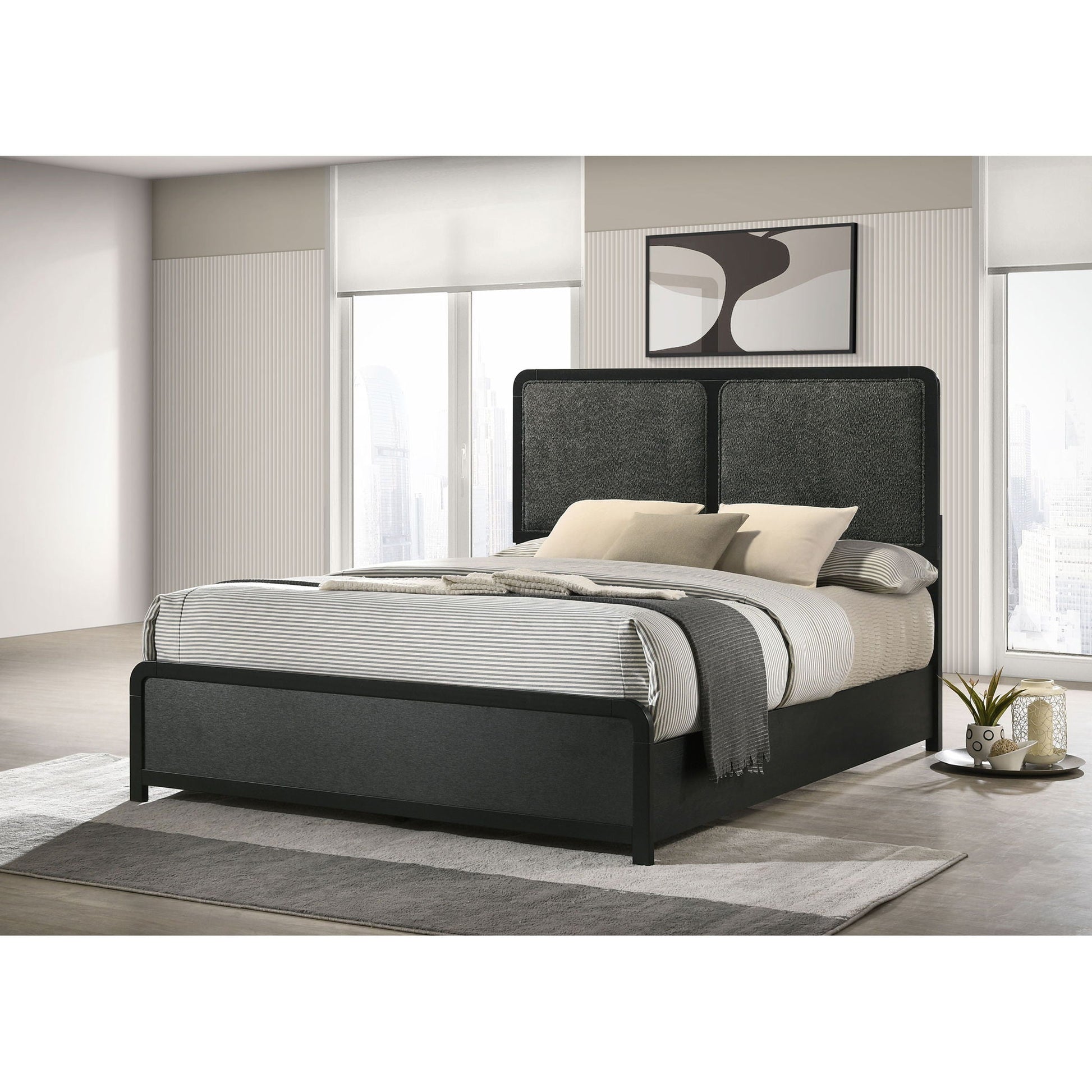 Burton bed with upholstered headboard in dark gray, panel bed frame with striped bedding on Tampa Home & Garden Store