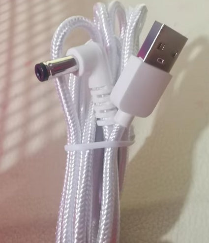 White braided USB charging cable with USB-A plug and metal DC barrel connector on Tampa Home & Garden Store