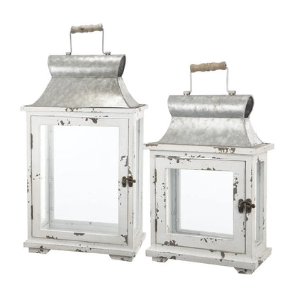 Two wooden candle lanterns in white distressed finish with galvanized metal tops on Tampa Home & Garden Store