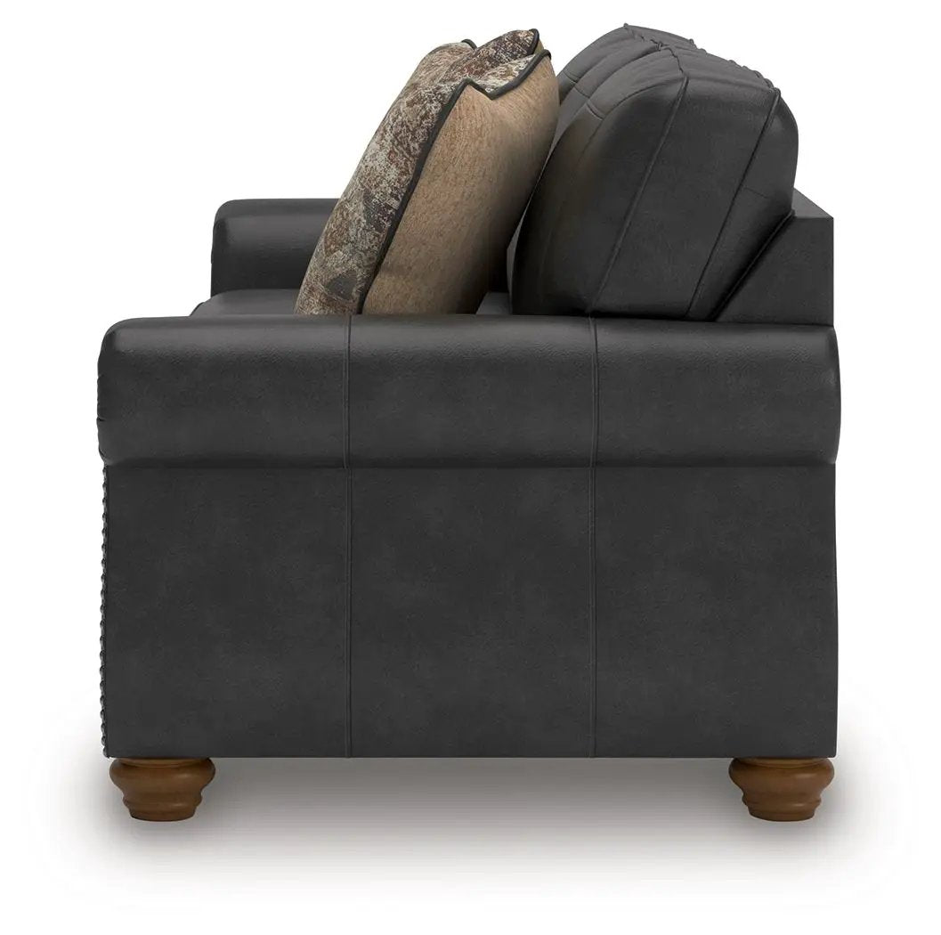 Chasemore sofa by Unique Piece Furniture, dark gray faux leather with wooden bun feet on Tampa Home & Garden Store
