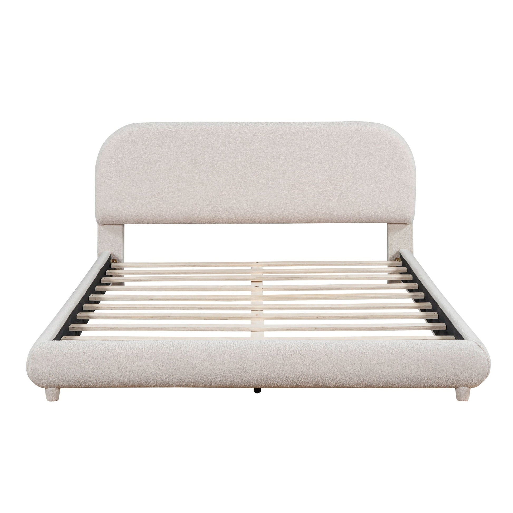 Upholstered platform bed with thick curved beige headboard and slatted frame on Tampa Home & Garden Store