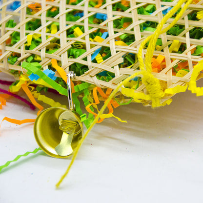 Bird brushed straw toy basket with colorful shredded paper and a metal bell on Tampa Home & Garden Store