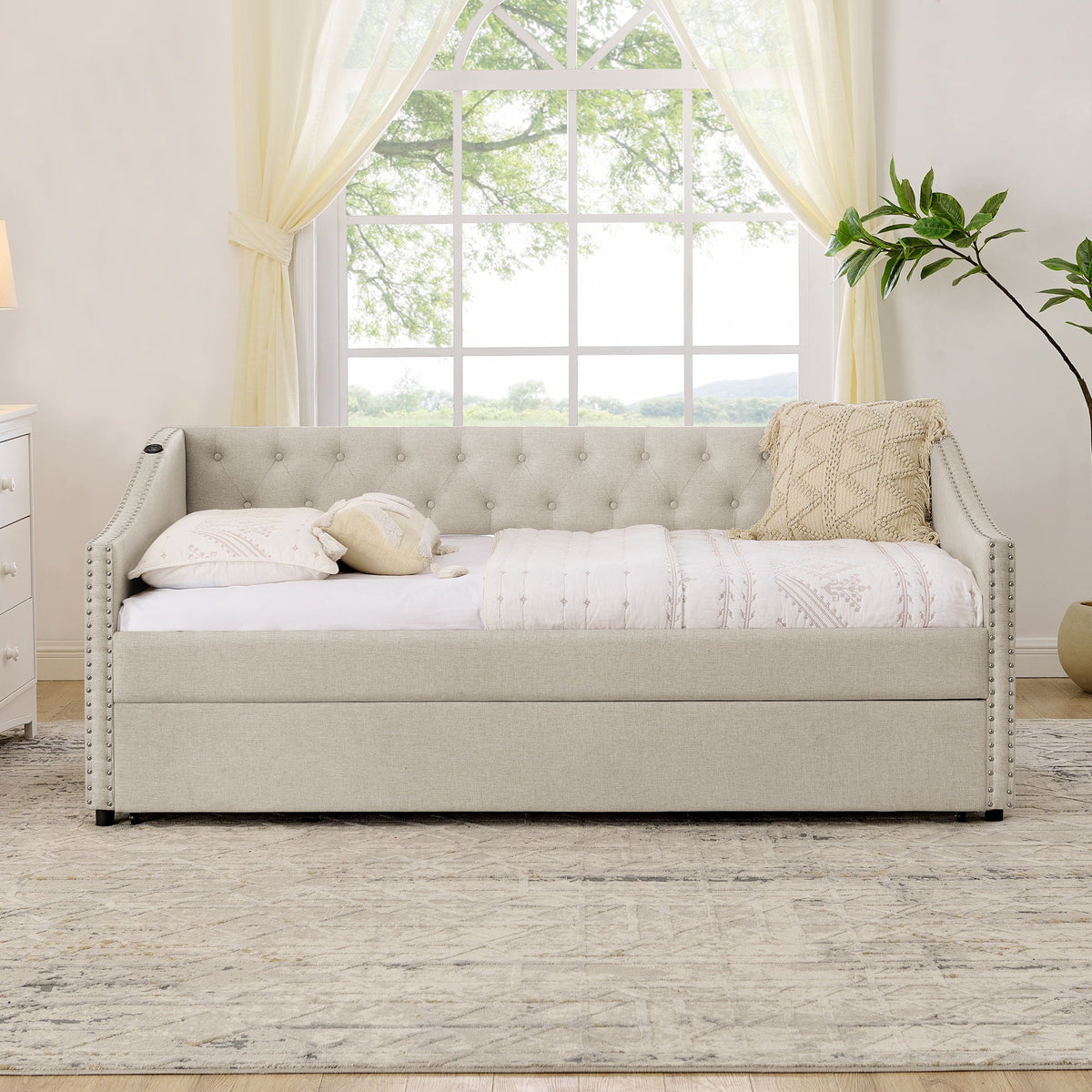 Gray upholstered daybed with tufted back, nailhead trim, and pull-out trundle on Tampa Home & Garden Store