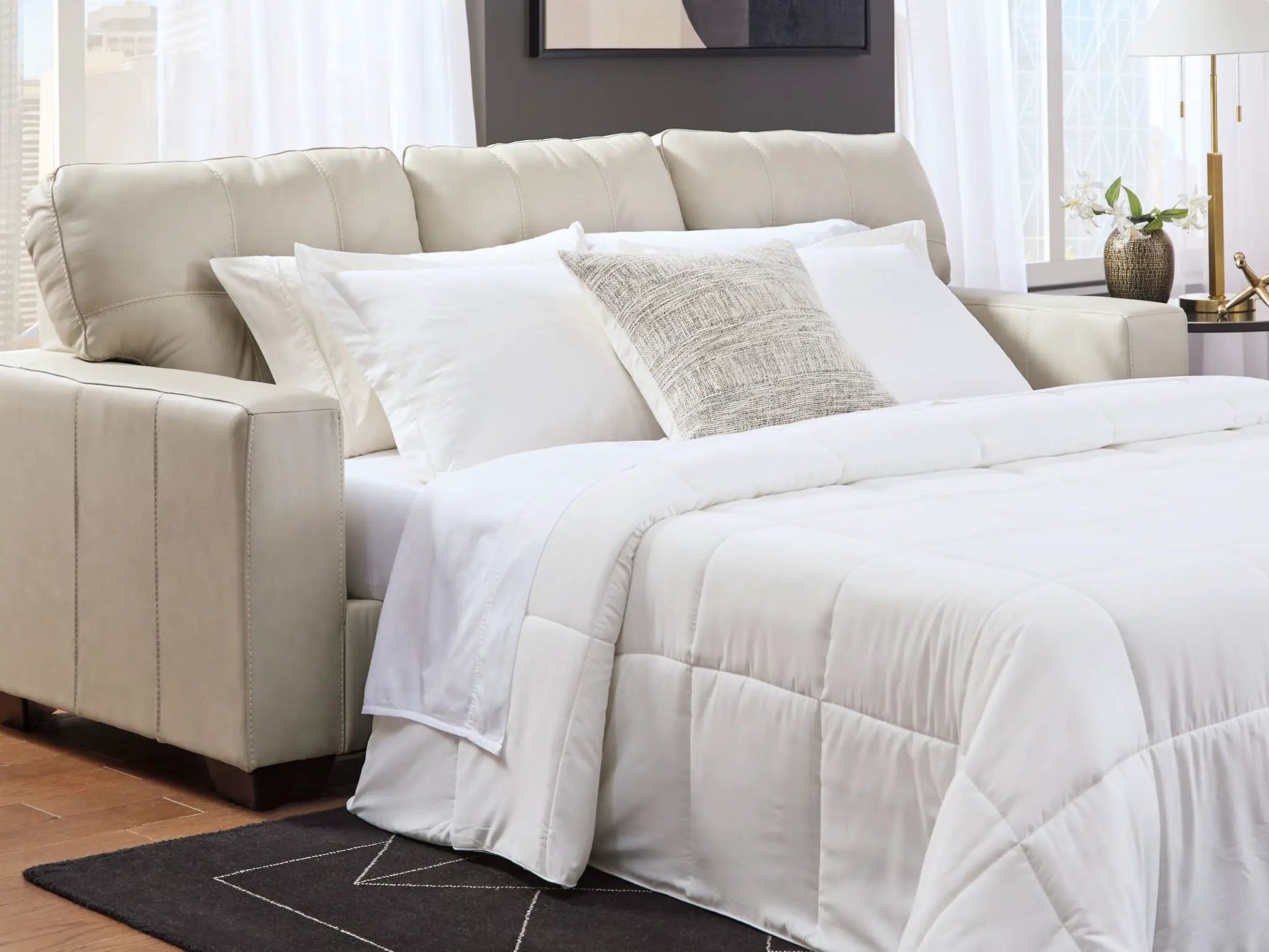 Santorine Sofa Sleeper cream leather with white bedding and textured pillow by Unique Piece Furniture on Tampa Home & Garden Store